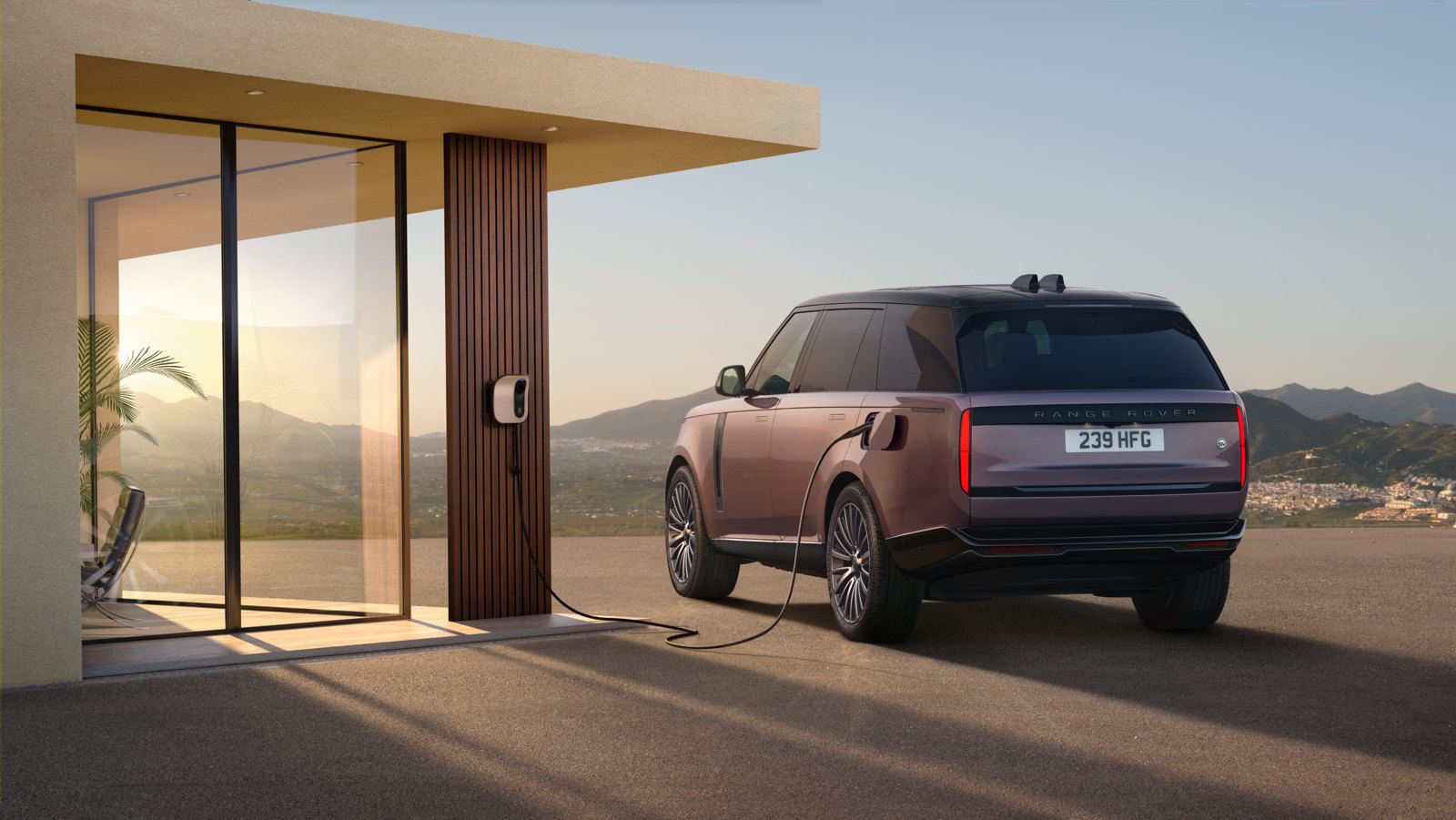 Range Rover Electric connected to a DC rapid charger, showing the 800-volt architecture behind the Range Rover Electric battery