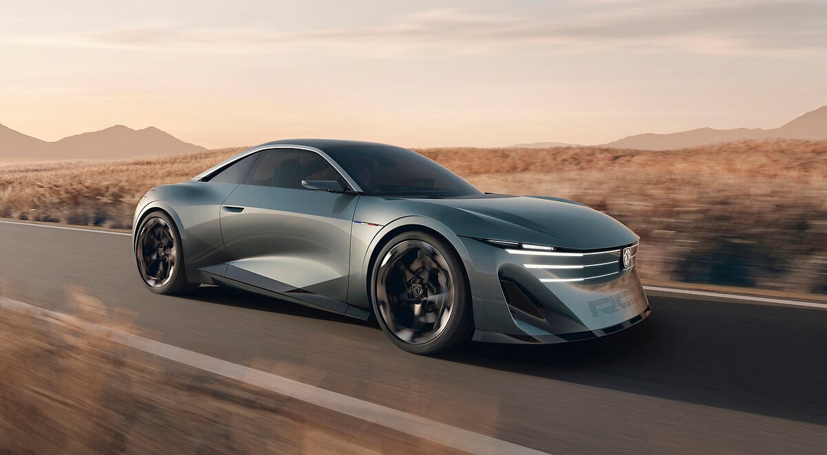Peugeot RCZ Vision concept in silver, front three-quarter view, driving on a road through dry grassland