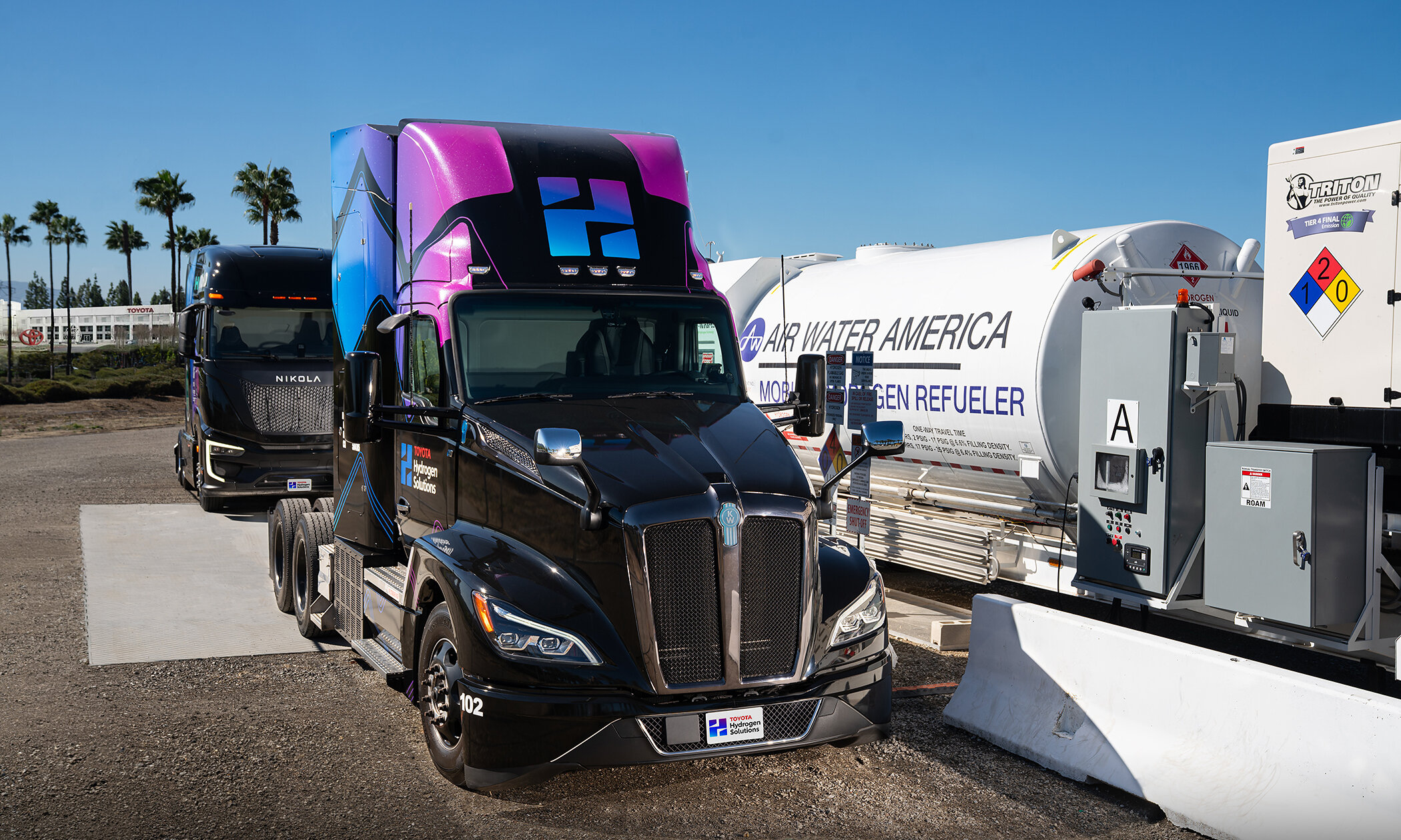 Toyota Hydrogen Solutions fuel cell semi truck parked beside a mobile hydrogen refueler at Toyota North American Parts Center California